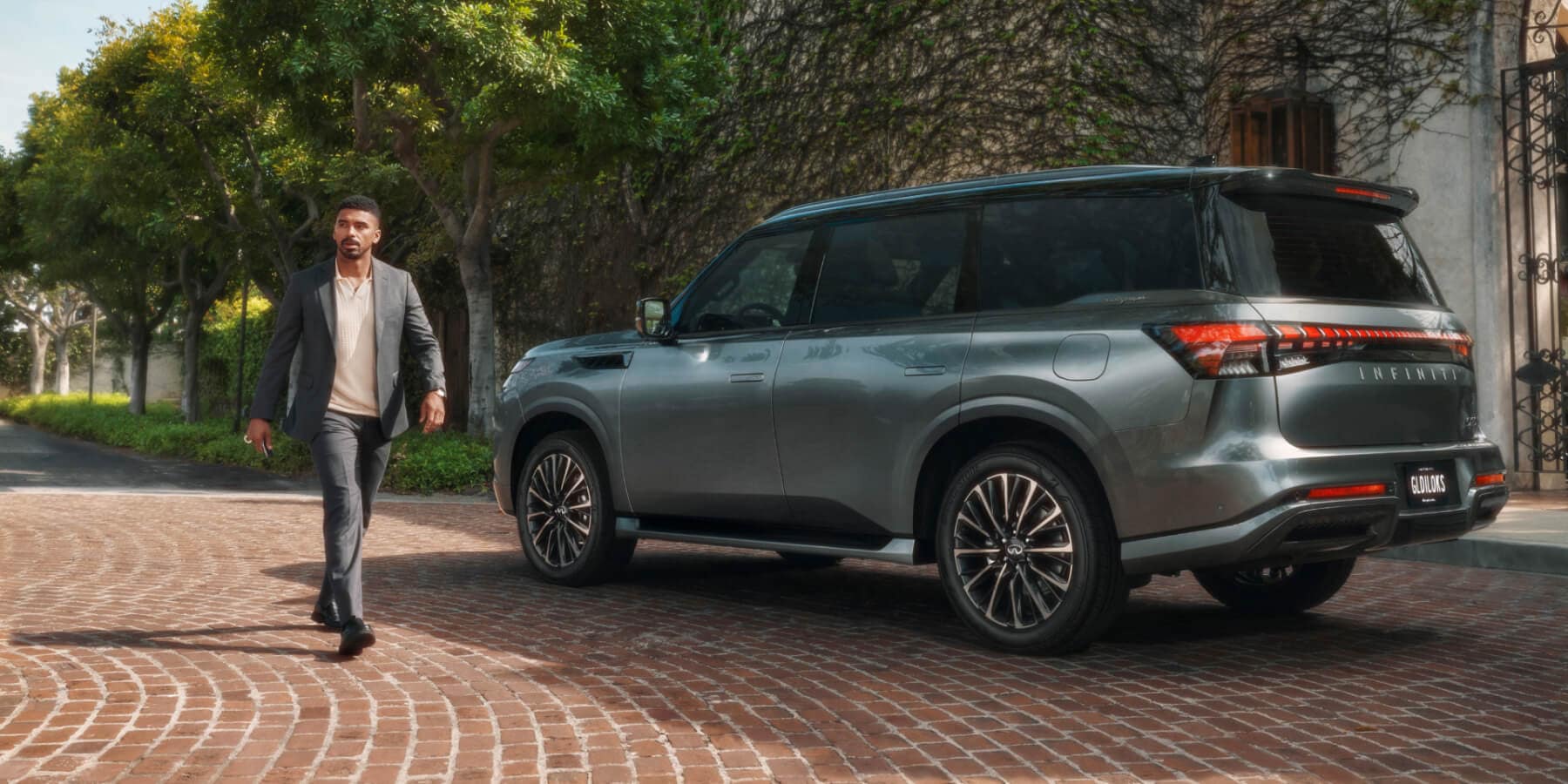 An INFINITI SUV traveling on an open road.