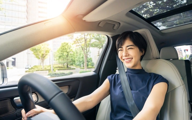 Woman smiling while driving a car